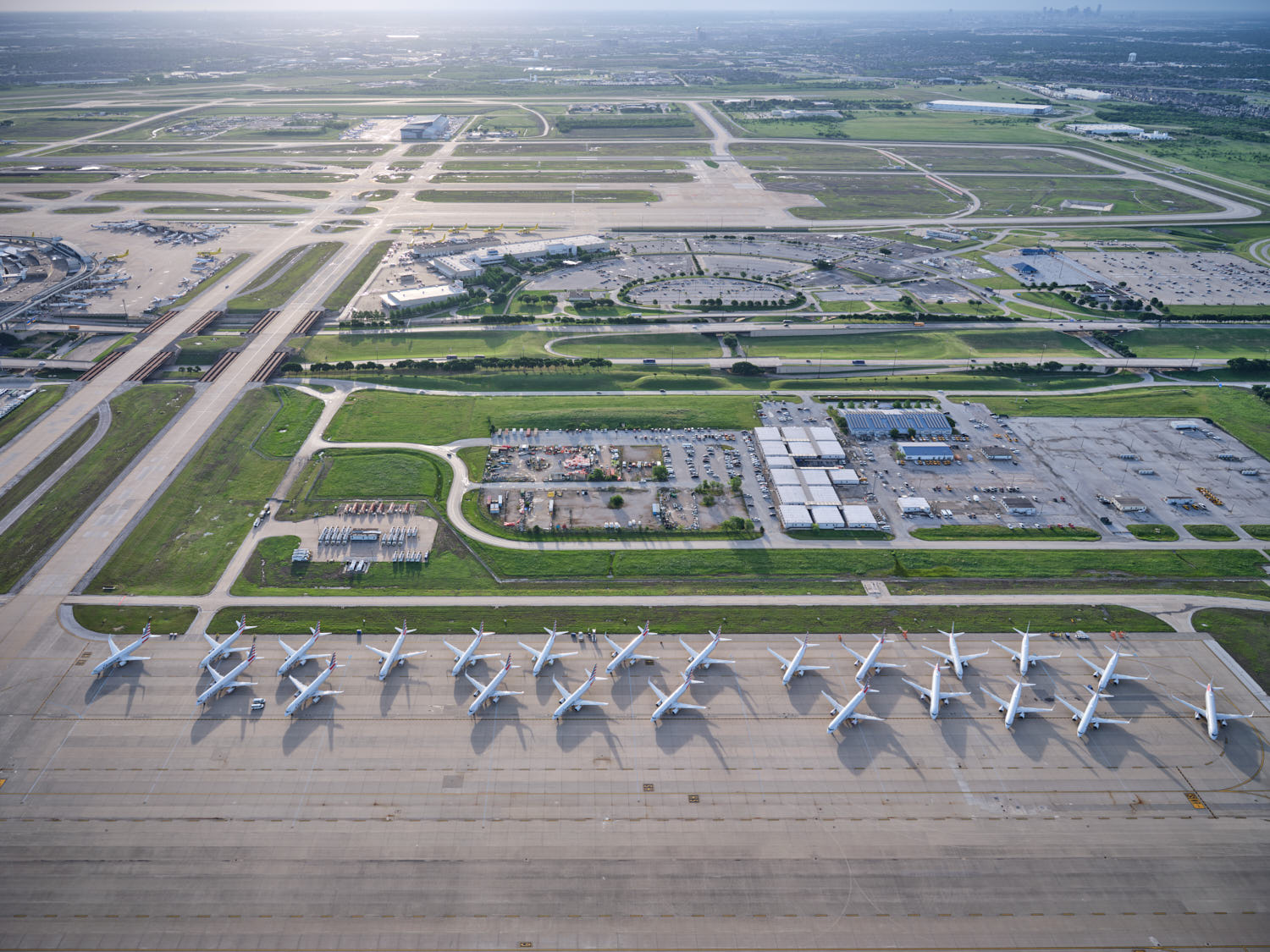 an aerial view of a runway with airplanes parked on it