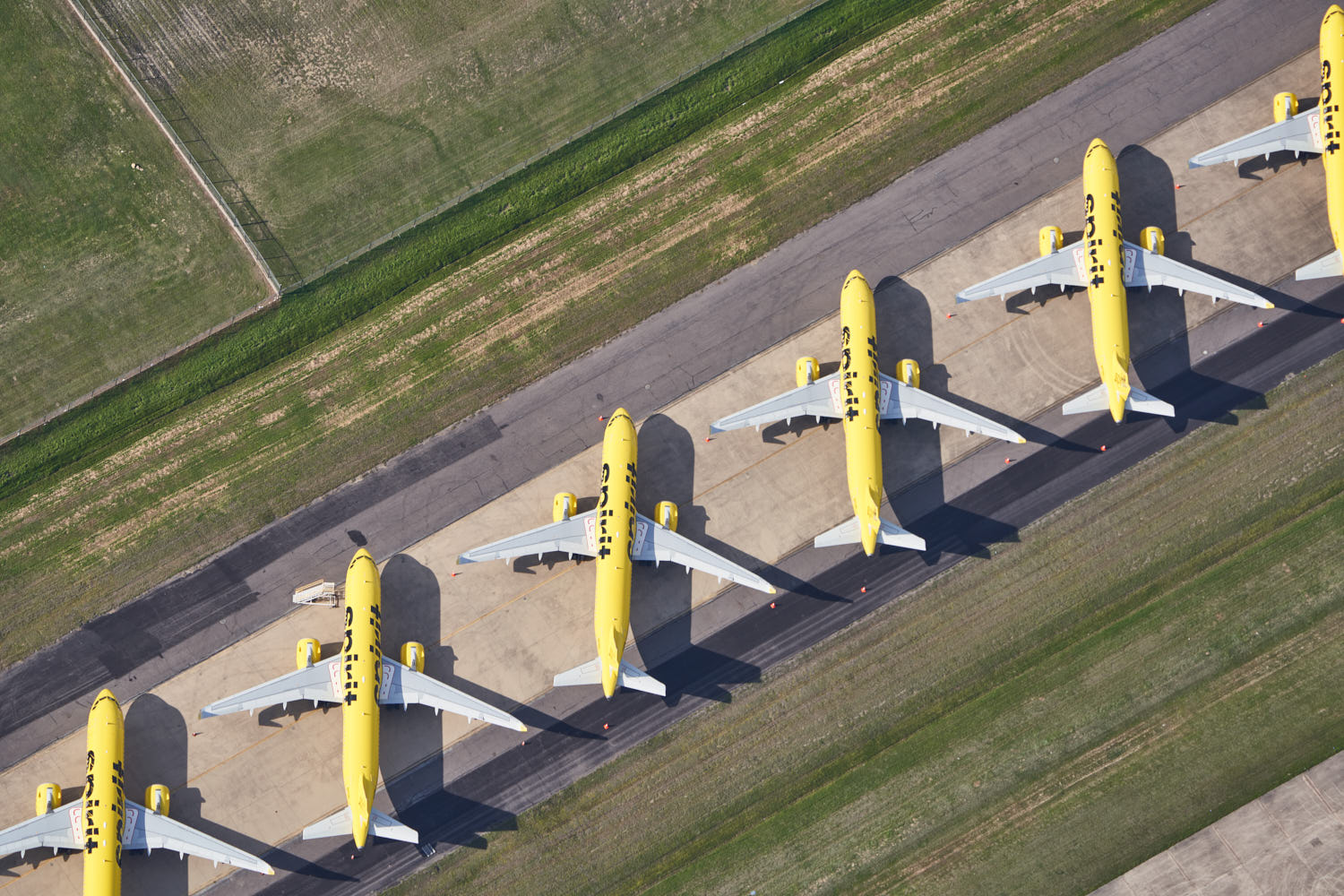a group of yellow airplanes on a runway