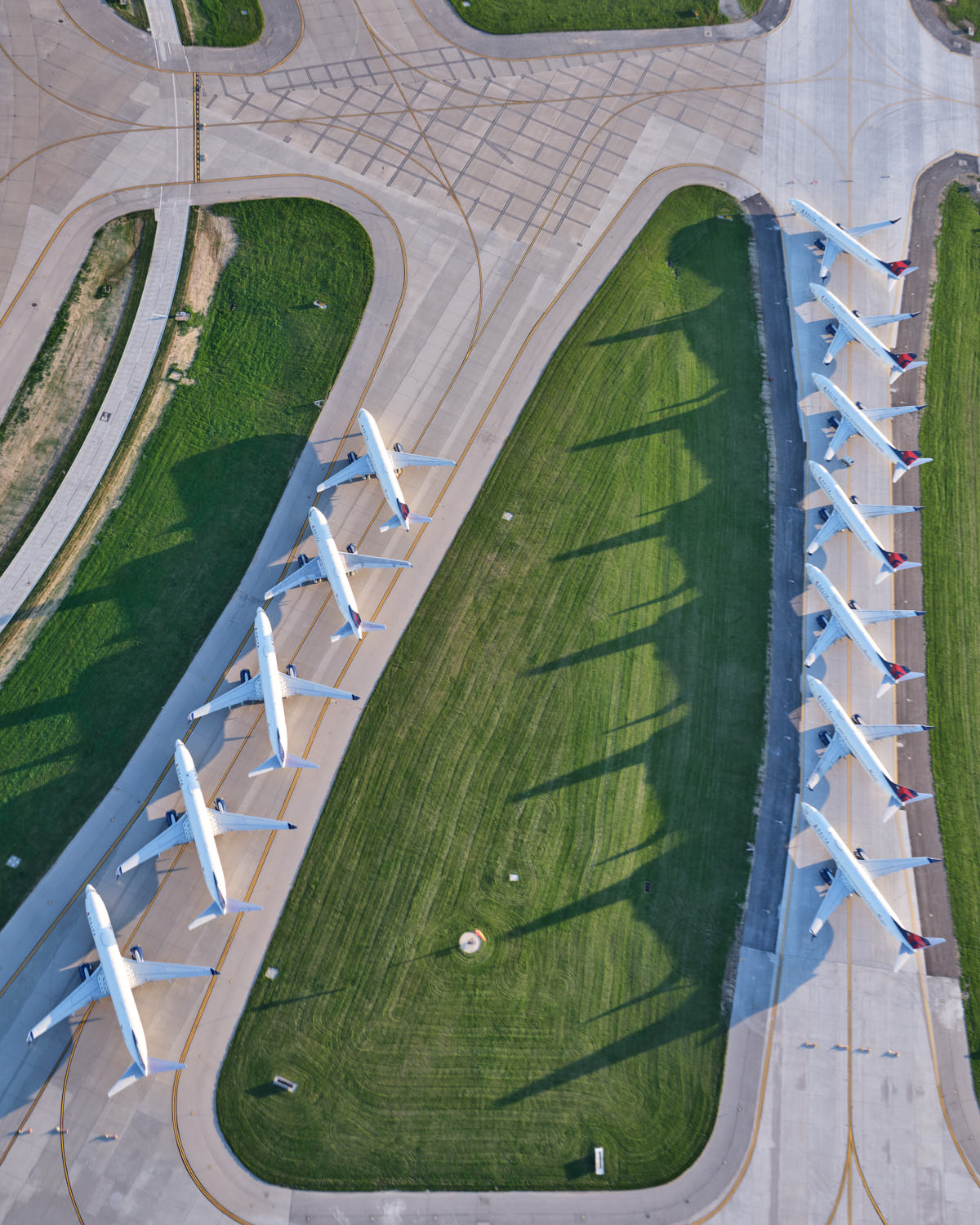an aerial view of airplanes on a runway