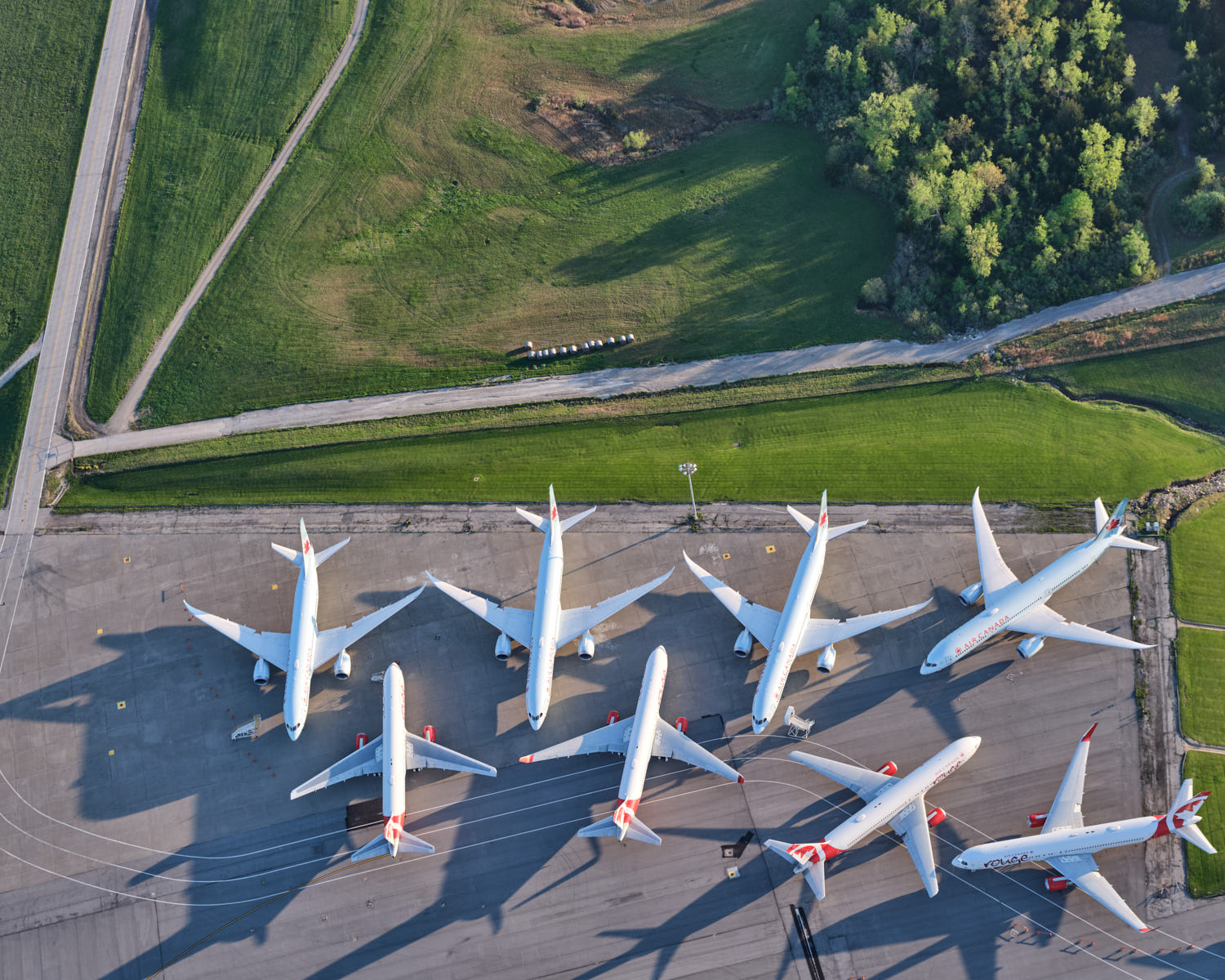 a group of white airplanes on a runway
