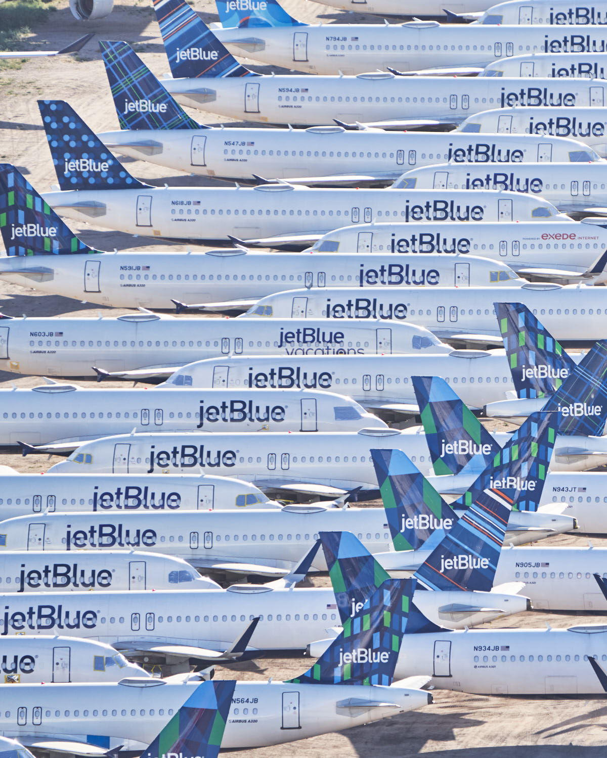 a group of airplanes with blue and white tail fin