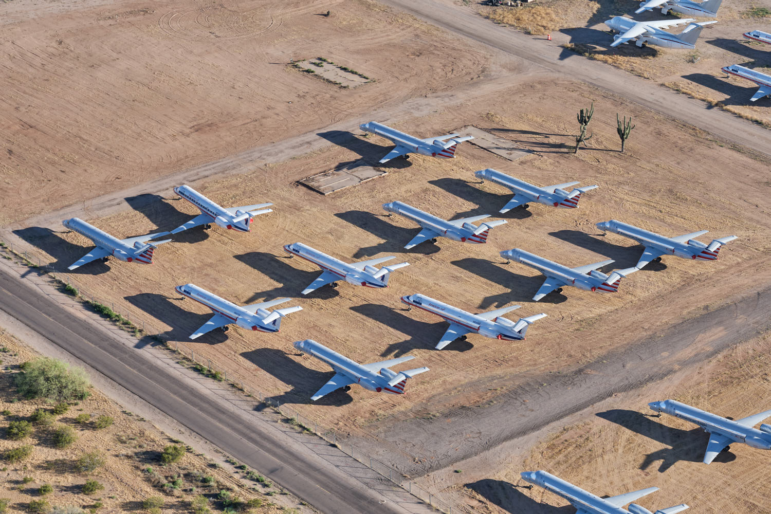 airplanes parked on a dirt field