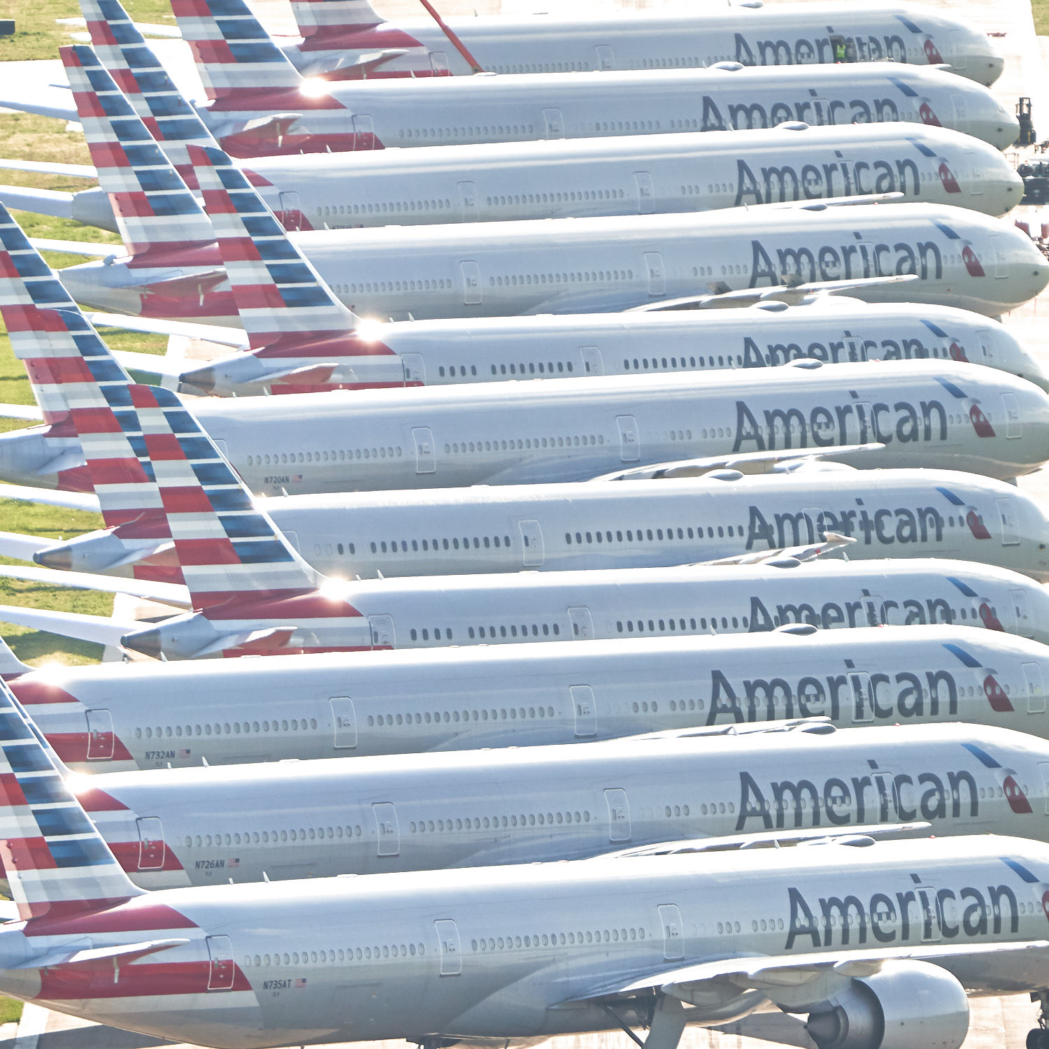 a row of airplanes with american flag tail fin