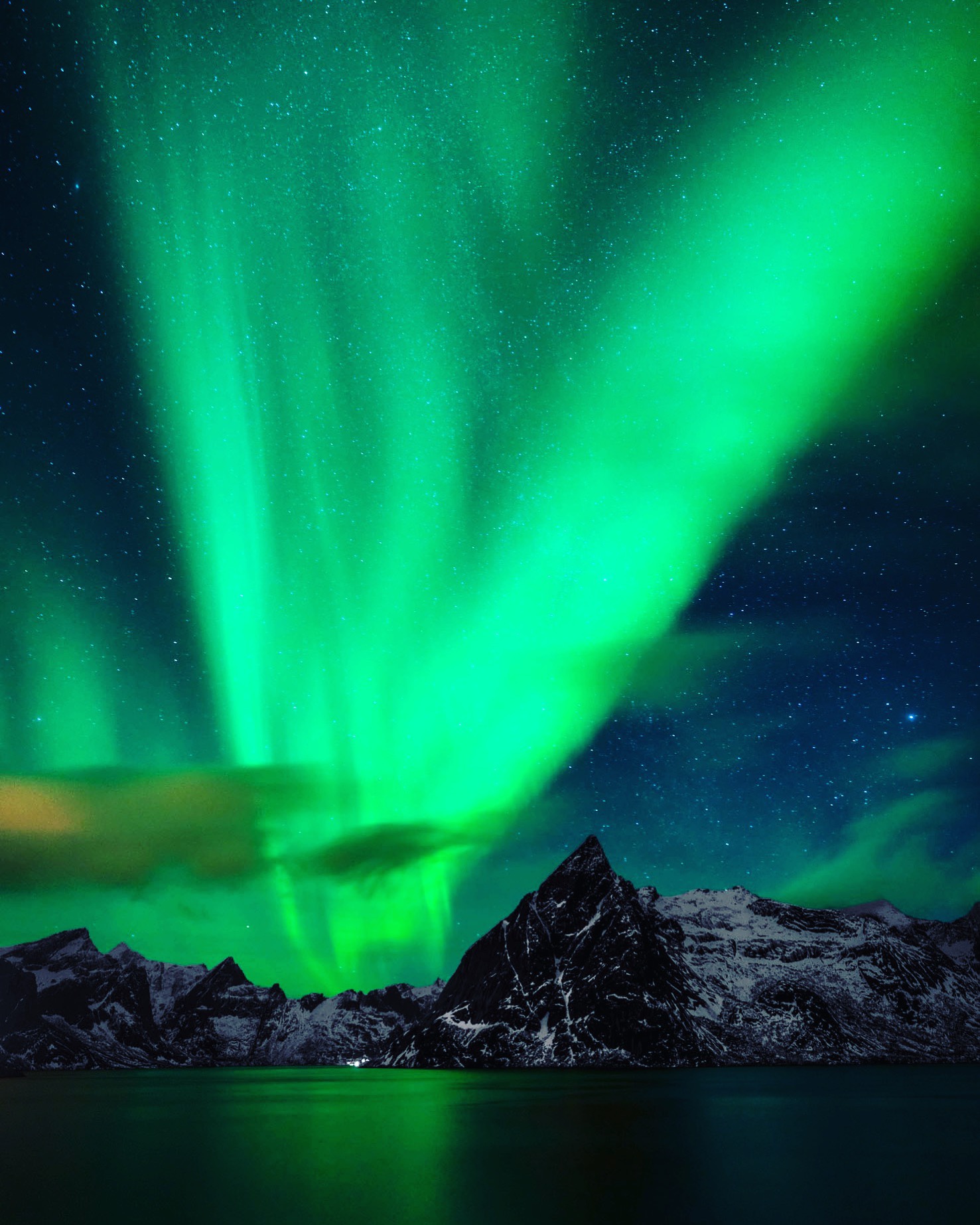 green lights in the sky over mountains