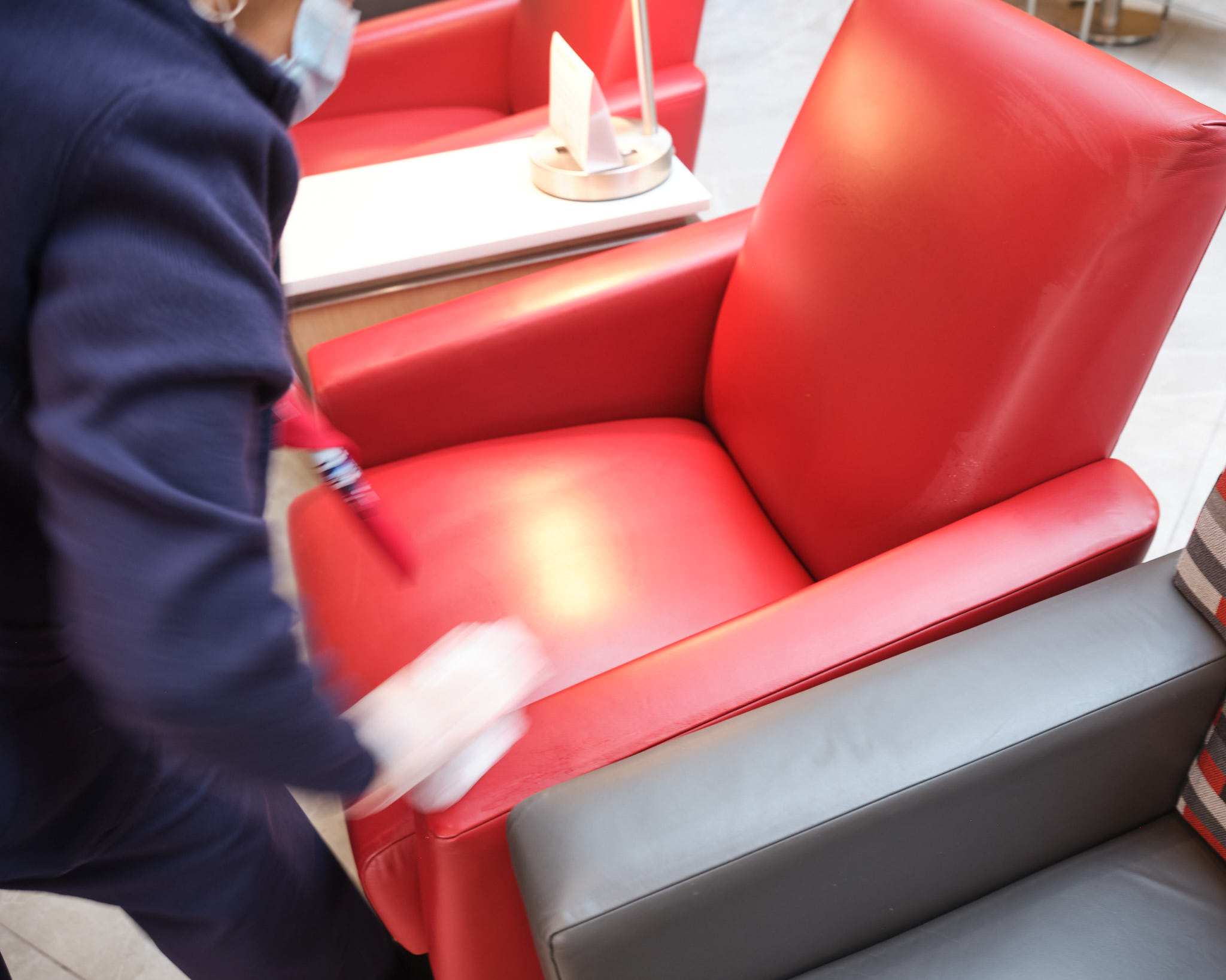 a person cleaning a red chair