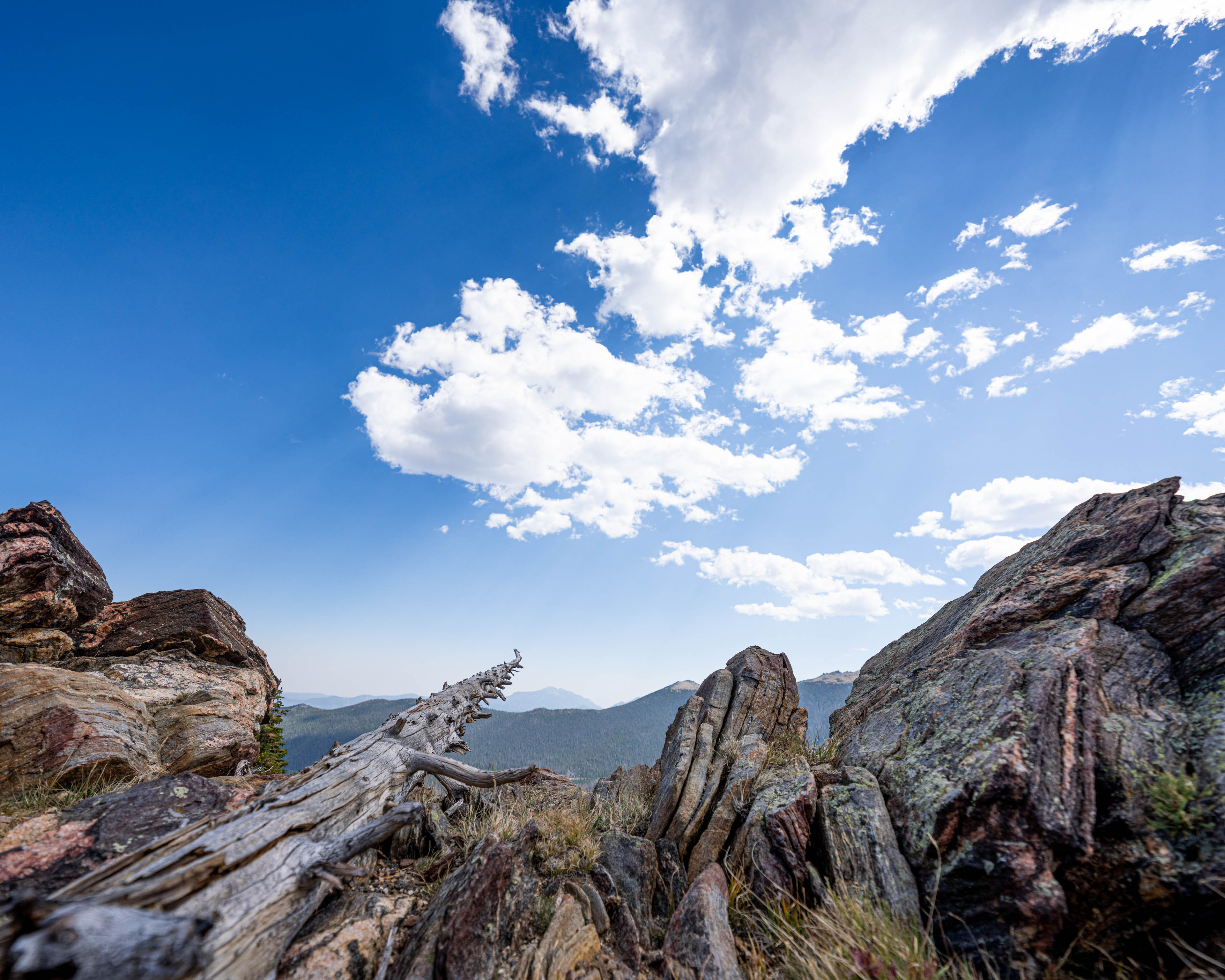 a rocky landscape with blue sky and clouds