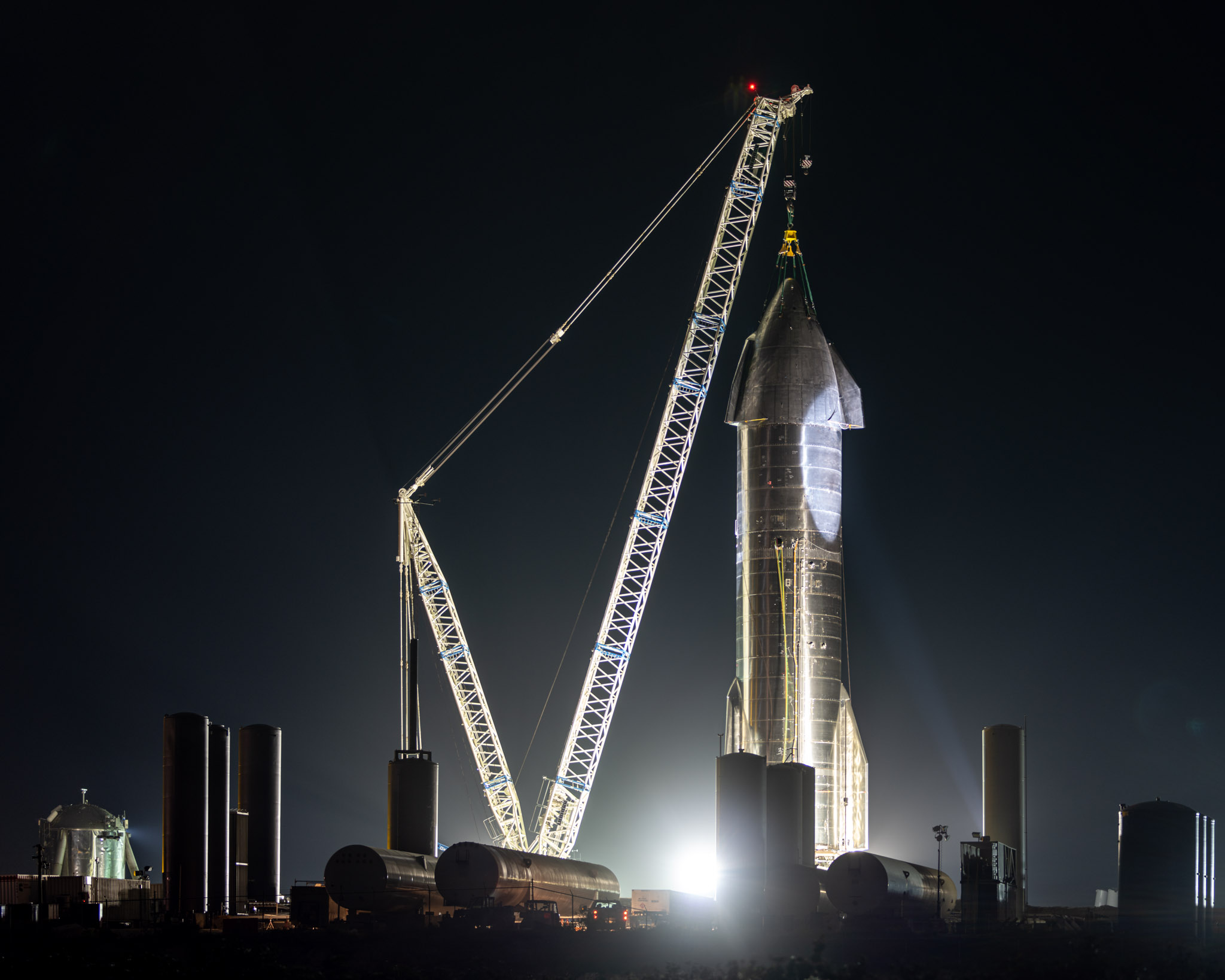 a rocket with a crane at night